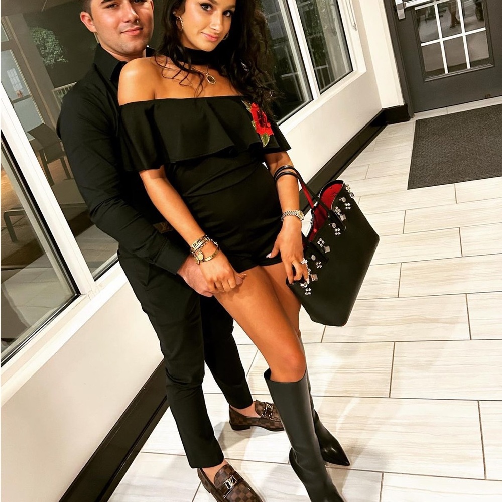 Romper with neck choker and shoulder ruffle and rose